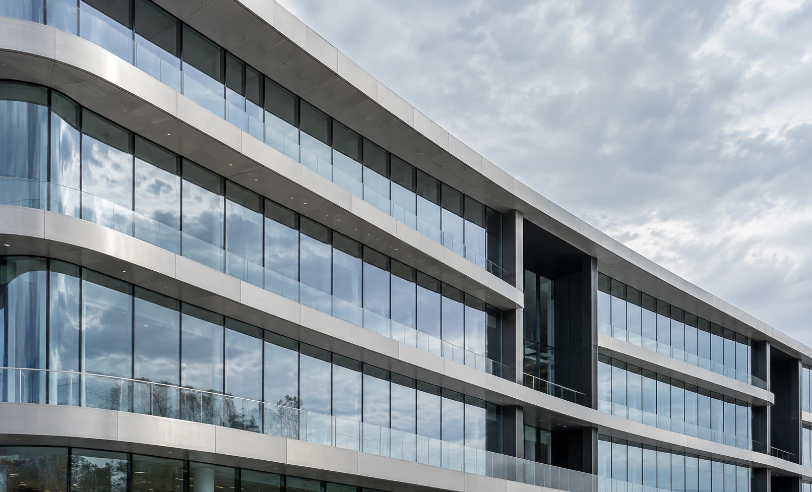 A sweeping glass elevation with projecting silver horizontal planes